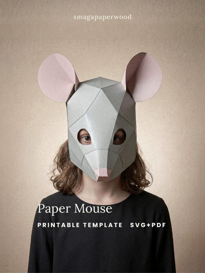 Hero (worn) — Low-poly paper mouse mask in grey and pink card, worn by a child as a half-mask
