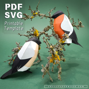 Two paper birds sitting on a branch
