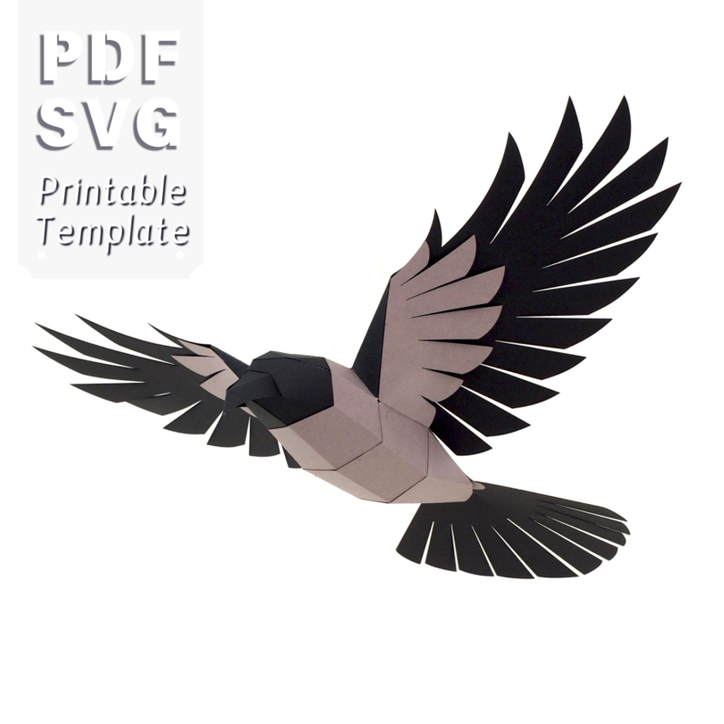 Geometric papercraft crow in mid-flight, crafted from black and gray paper. The bird features angular, faceted wings and a streamlined body, giving it a striking, modern look. Designed as a DIY printable template for assembly.