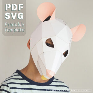 Child wearing a geometric white paper rat mask with pink ears and nose. The mask has a faceted low-poly design with cut-out eye holes and a small yellow paper detail resembling a tooth. Text on the image reads 'PDF SVG Printable Template' and 'SmagaPaperwood.com'
