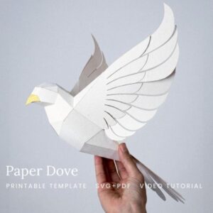Low-poly paper dove sculpture in white card, held in a hand to show its size